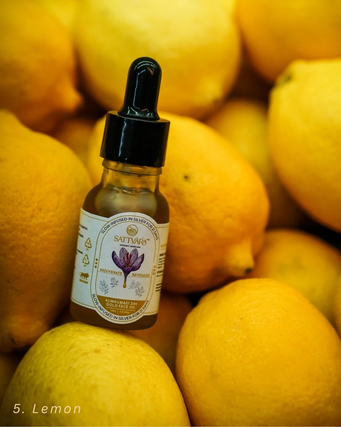 The Sattvāra face oil bottle among fresh lemons.