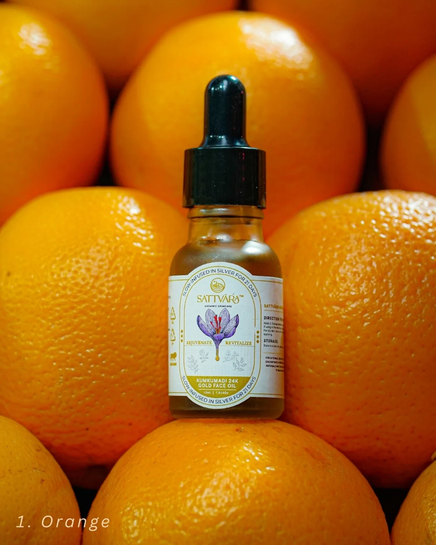 The Sattvāra face oil bottle resting among oranges.