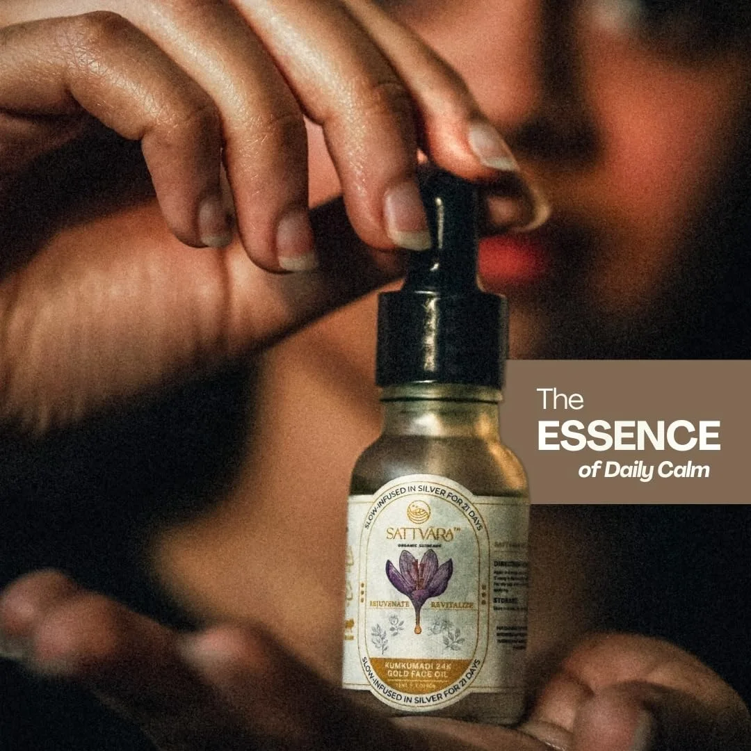 A hand holding the Sattvāra face oil bottle.