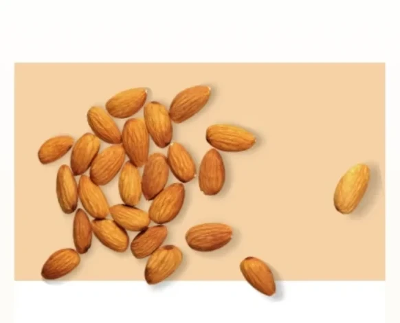 Whole shelled almonds scattered on a warm apricot ground